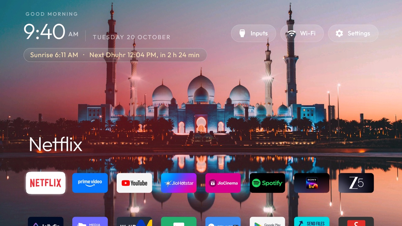 After: a mosque photo as wallpaper, the next prayer time in a gold pill under the clock, and eight apps in one row